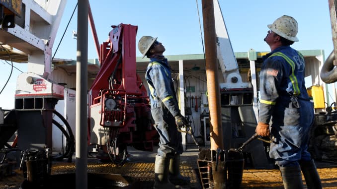 A drilling crew secures a stand of drill pipe into the mouse hole on a drilling rig near Midland, Texas February 12, 2019.