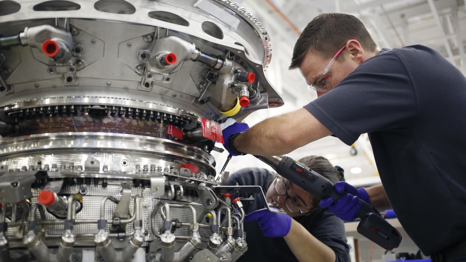 Employees use hand tools to assemble components of a LEAP jet engine at the General Electric Aviation plant in Lafayette, Indiana, July 19, 2019.