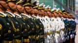 Members of the People's Liberation Army stand in formation during a flag raising ceremony in Hong Kong, China, on Sunday, June 30, 2019.