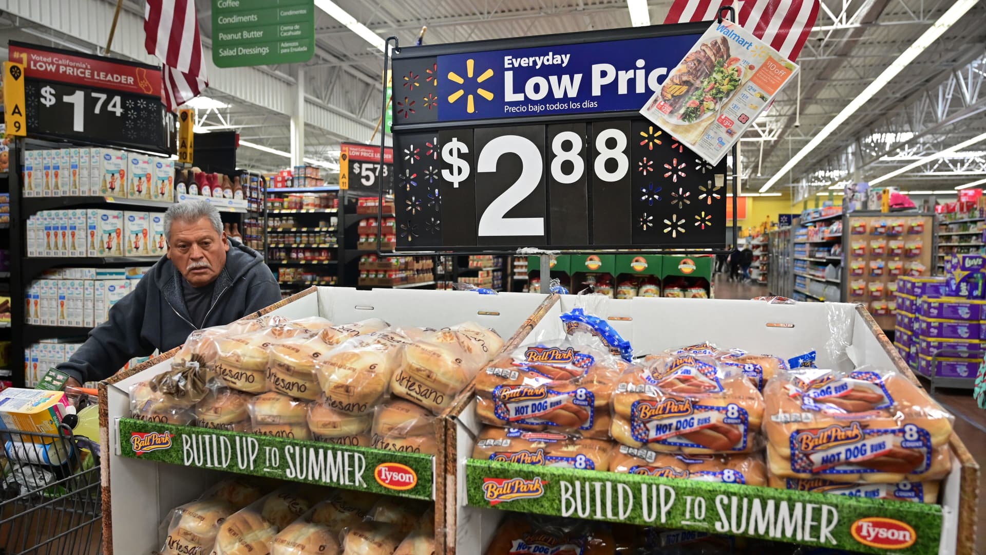 A man pushes his shopping cart past bread for sale at a Walmart SuperCenter store in Rosemead, California.