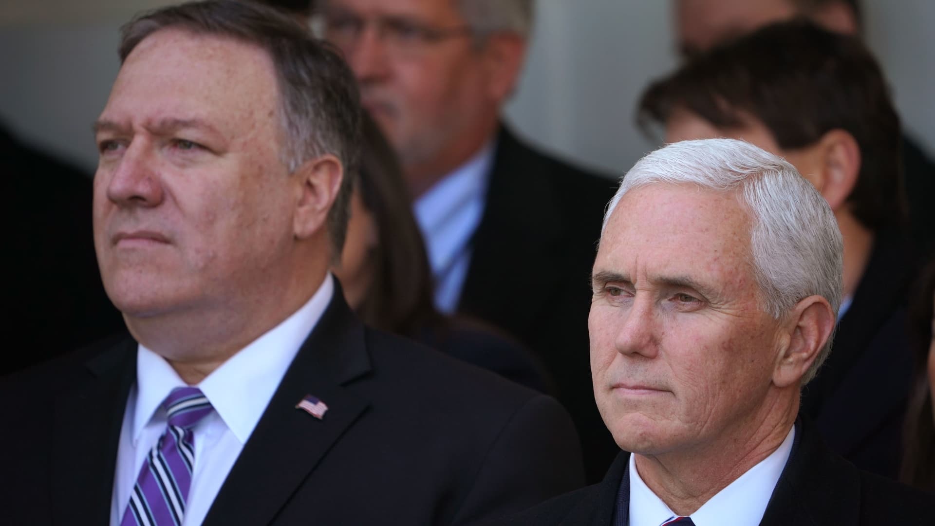 US Secretary of State Mike Pompeo (L) and Vice President Mike Pence listen as President Donald Trump speaks about the government shutdown on January 25, 2019, from the Rose Garden of the White House in Washington, DC. - Trump says will sign bill to reopen the government until February 15.