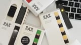 A Juul Labs Inc. e-cigarette, USB charger, and flavored pods are arranged for a photograph in the Brooklyn Borough of New York.
