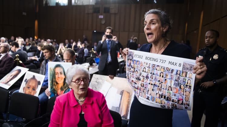 Families hold photos of 737 Max victims as Boeing's CEO testifies before Congress