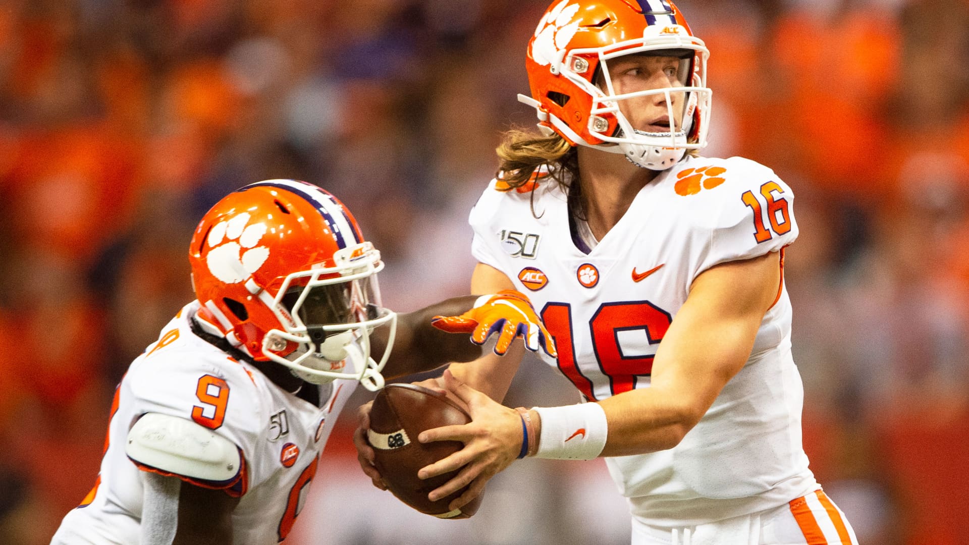 Clemson Tigers Quarterback Trevor Lawrence (16) fakes a handoff to Clemson Tigers Running Back Travis Etienne (9) during the first quarter of the game between the Clemson Tigers and the Syracuse Orange on September 14, 2019, at the Carrier Dome in Syracuse, NY.