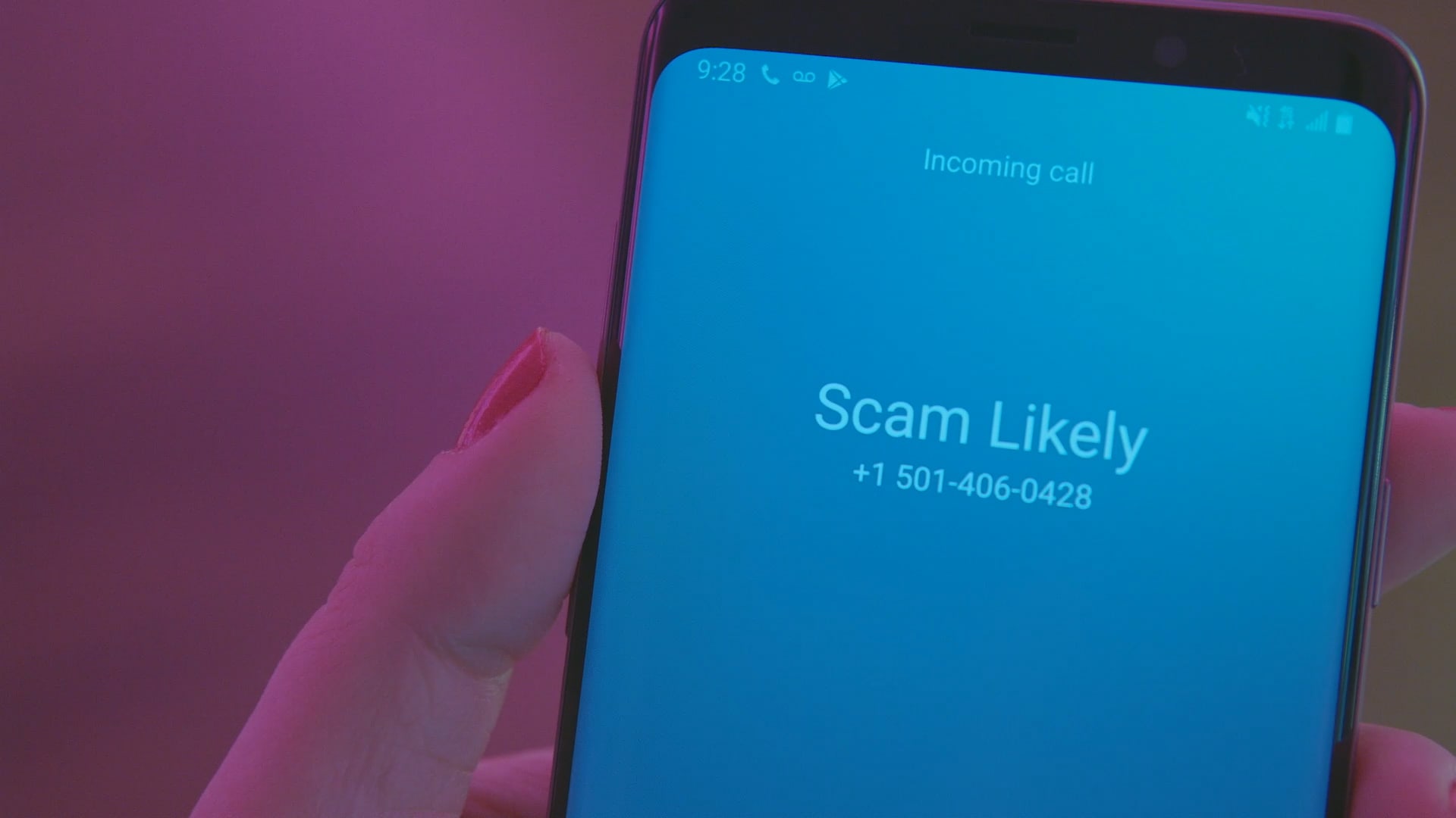 An incoming call is labeled as Scam Likely on a T-Mobile phone