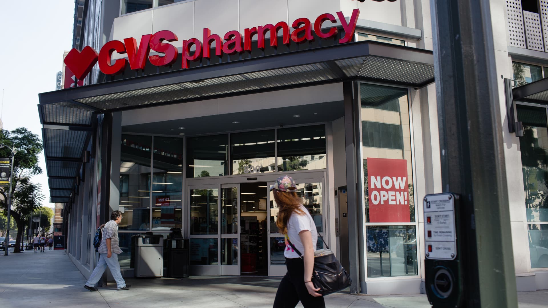 A customer walks towards the entrance of a CVS Health Corp. store in downtown Los Angeles, California, U.S., on Friday, Oct. 27, 2017.