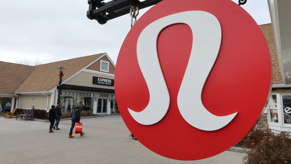 A Lululemon sign hangs in front of their store at the Woodbury Commons Premium Outlets shopping mall on November 17, 2019 in Central Valley, New York.