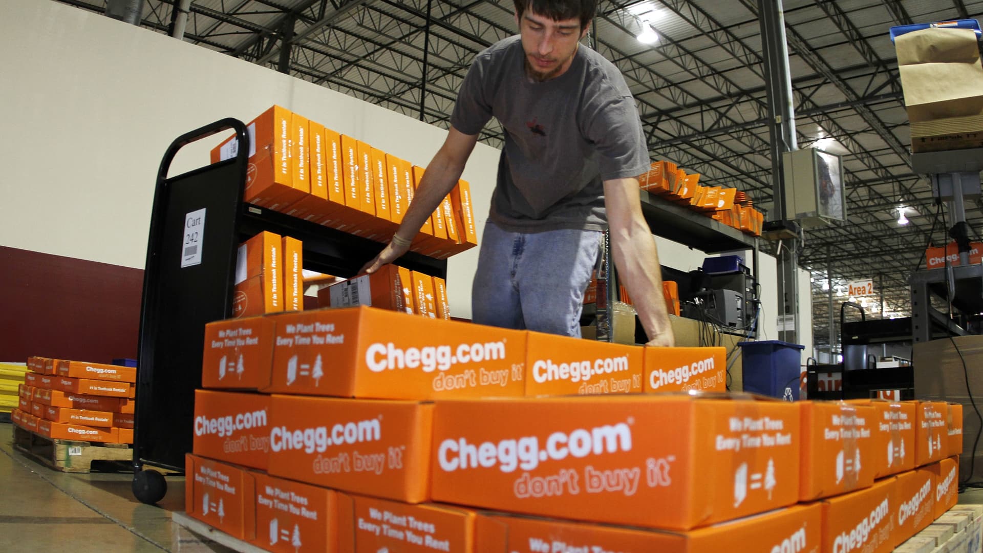 James Tahaney loads textbooks on to a pallet in preparation for shipping at the Chegg warehouse in Shepherdsville, Kentucky, April 29, 2010.