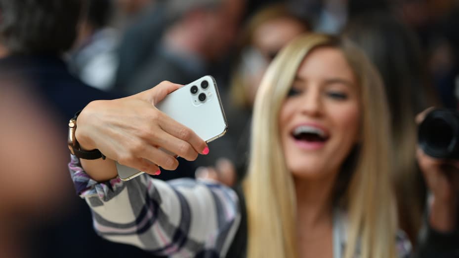 A woman tries out a new Apple 11 Pro during an Apple product launch