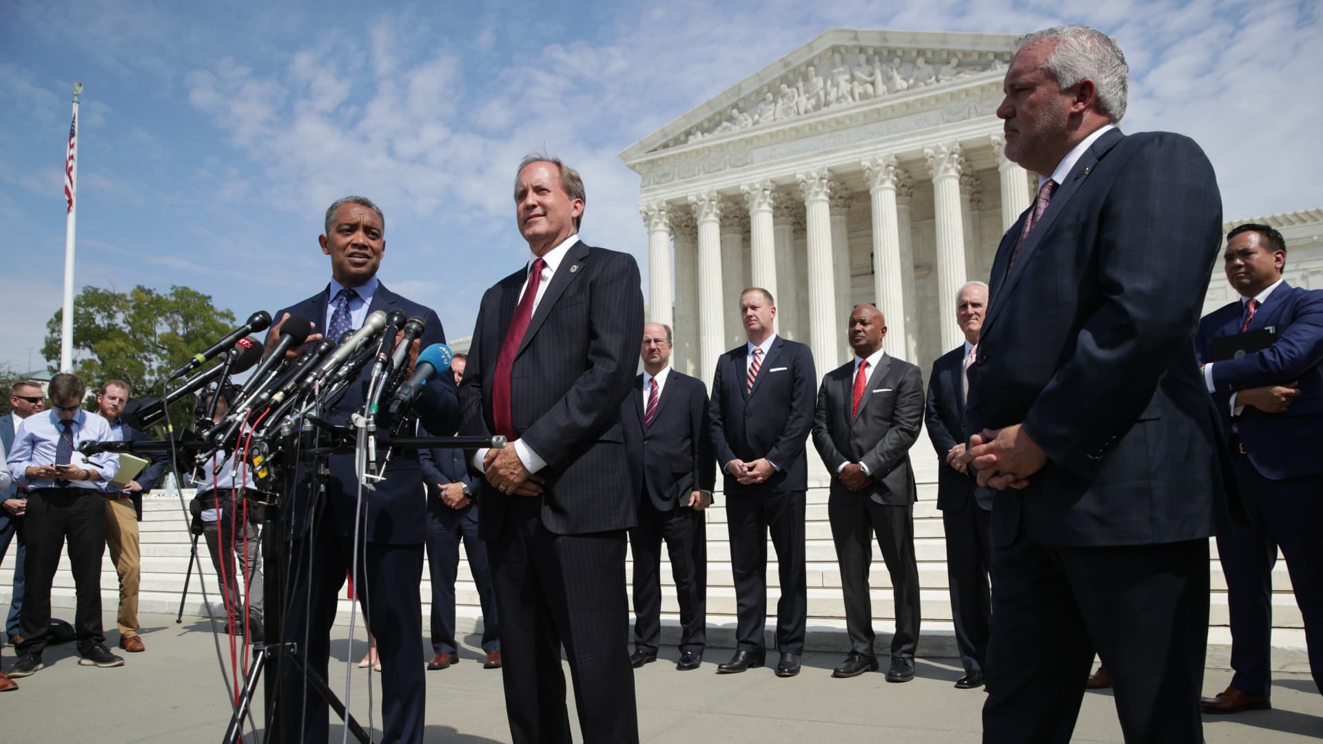 (L-R) Washington, DC Attorney General Karl Racine (L) speaks as Arkansas Attorney General Leslie Rutledge and Texas Attorney General Ken Paxton listens during a news conference in front of the U.S. Supreme Court September 9, 2019 in Washington, DC.