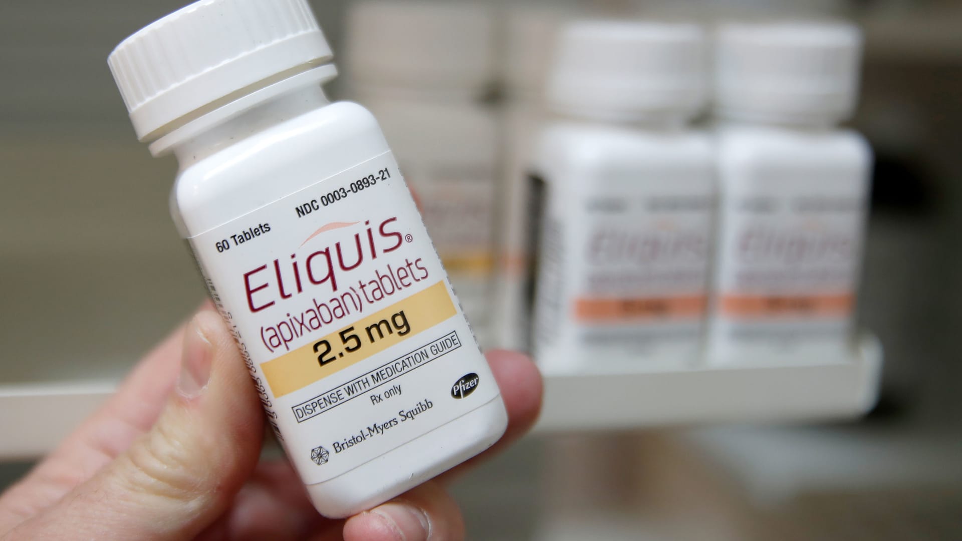 A pharmacist holds a bottle of the drug Eliquis, made by Pfizer Pharmaceuticals, at a pharmacy in Provo, Utah, January 9, 2020.