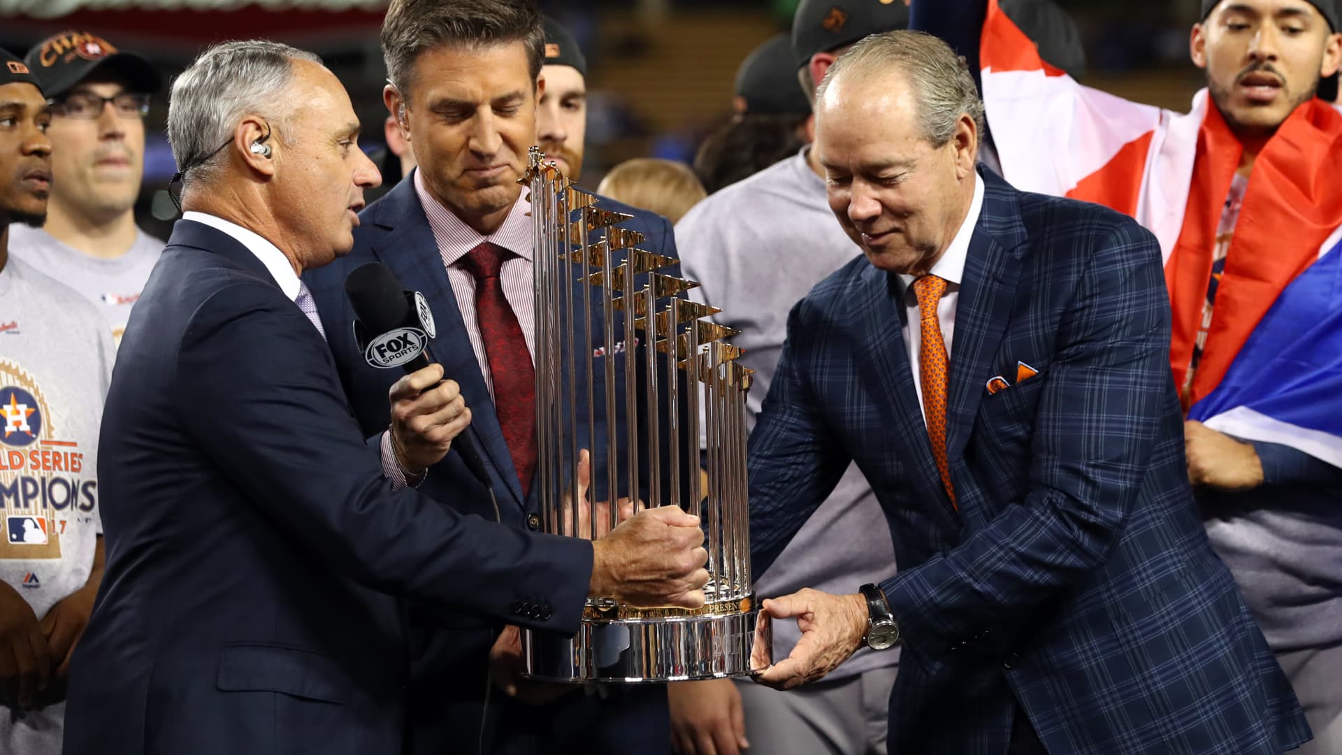 Major League Baseball Commissioner Robert D. Manfred Jr. presents the Commissioner's Trophy to the Houston Astros owner Jim Crane after the Astros defeated the Los Angeles Dodgers in Game 7 of the 2017 World Series at Dodger Stadium on Wednesday, November 1, 2017 in Los Angeles, California.