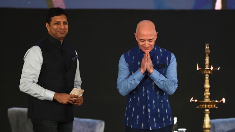 Amazon's Jeff Bezos announces $1 billion investment into India businesses as business owners protest his visit