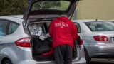A DoorDash Inc. delivery person arranges an order in the back of a vehicle outside of a DoorDash Kitchens location in Redwood City, California, U.S., on Friday, Nov. 29, 2019.