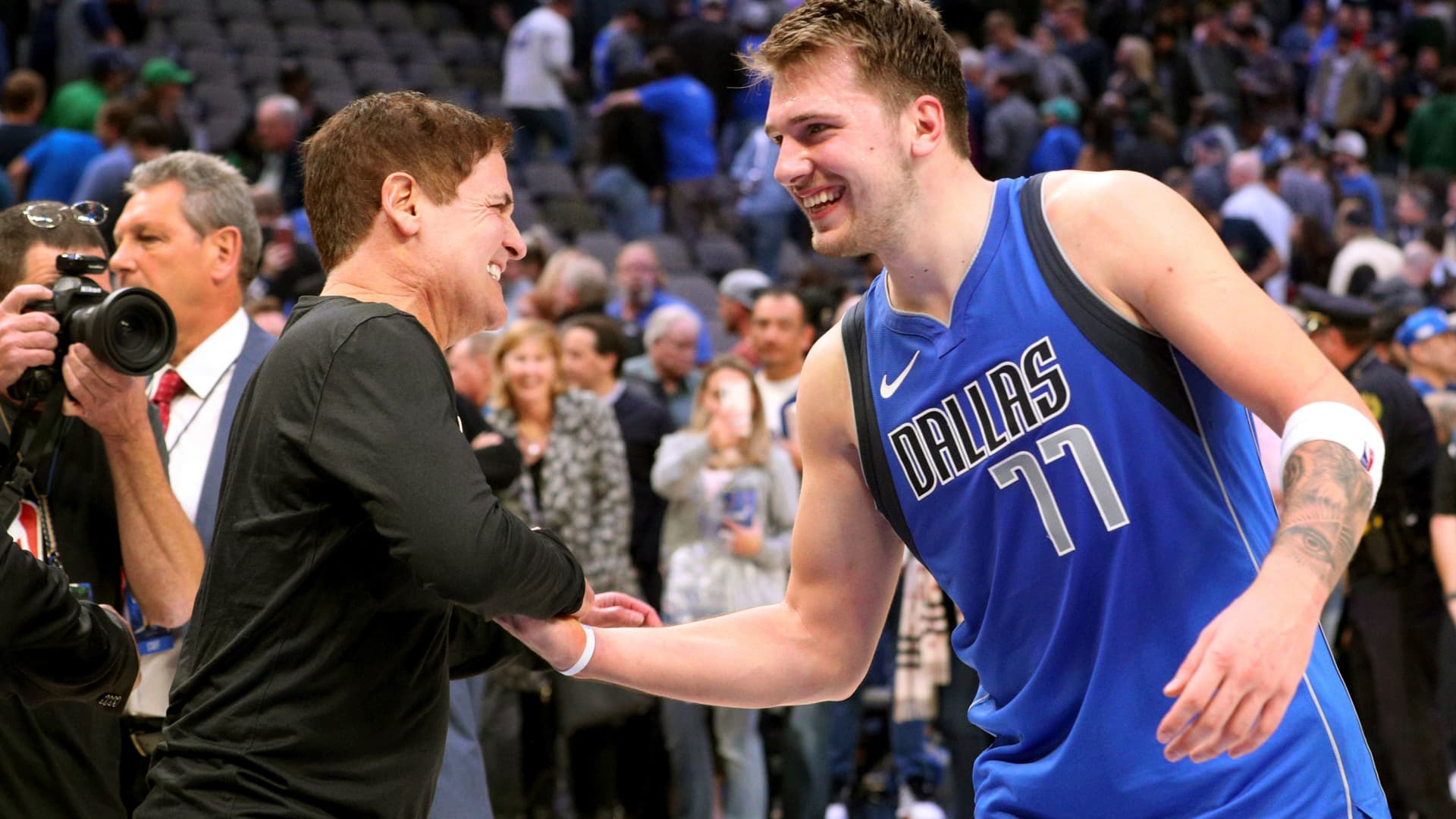 Dallas Mavericks owner Mark Cuban shakes hands with Luka Doncic (77) after the 117-110 win over the San Antonio Spurs in an NBA basketball game Monday, Nov. 18, 2019, in Dallas.