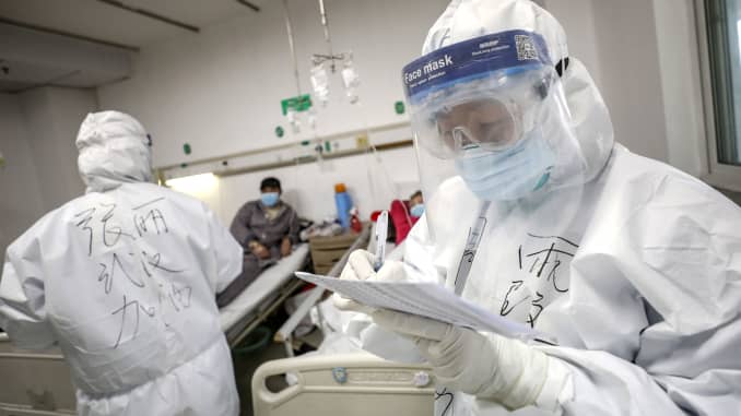 A medical worker in a protective suit checks a patient's records at Jinyintan hospital in Wuhan, the epicentre of the novel coronavirus outbreak, in Hubei province, China February 13, 2020.