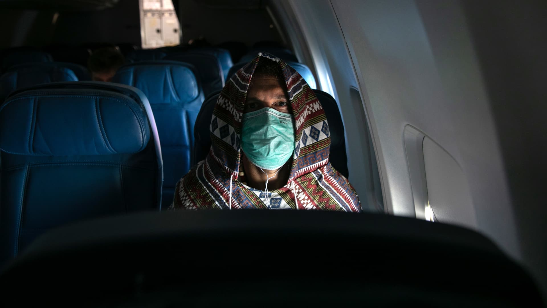 Adam Carver, 38, wears a mask to protect against coronavirus while on a nearly empty Delta flight from Seattle-Tacoma International Airport o JFK on March 15, 2020 near New York City.