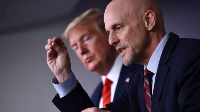 US President Donald Trump listens to FDA Commissioner Stephen Hahn (R) speak on the latest developments of the coronavirus outbreak, in the James Brady Press Briefing Room at the White House March 19, 2020 in Washington, DC.