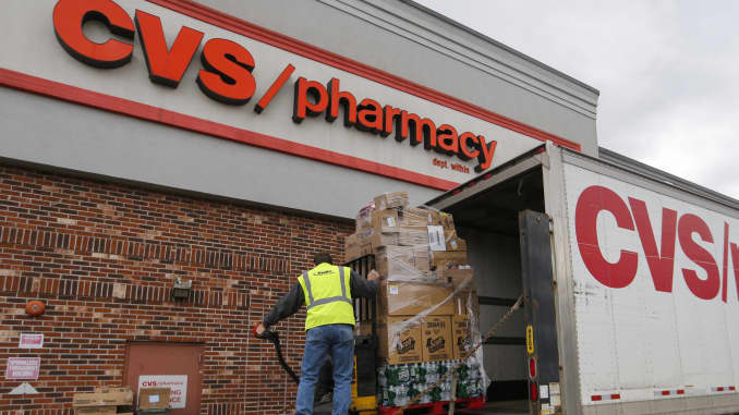 A driver unloads merchandise from a delivery truck outside a CVS Health Corp. location in New Rochelle, New York, U.S., on Monday, March 16, 2020.