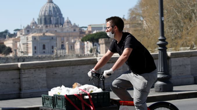 A delivery person passes near St. Peter's Basilica, as Italy tightens measures to try and contain the spread of coronavirus disease (COVID-19), in Rome, Italy.