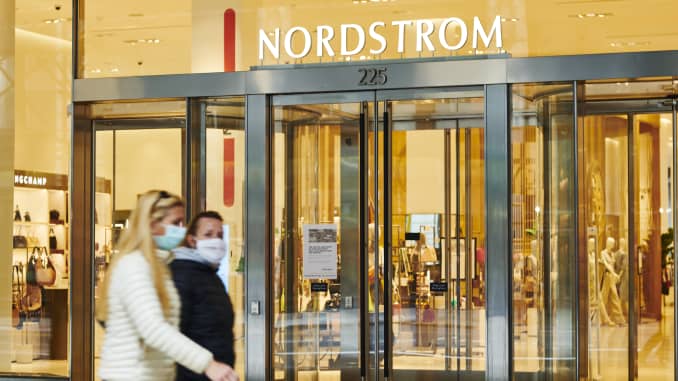 Pedestrians pass in front of a Nordstrom Inc. store in the Midtown neighborhood of New York, on Friday, March 20, 2020.