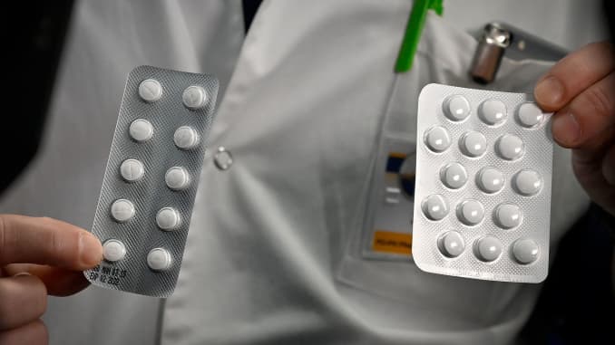 Medical staff shows on February 26, 2020 at the IHU Mediterranee Infection Institute in Marseille, packets of a Nivaquine, tablets containing chloroquine and Plaqueril, tablets containing hydroxychloroquine, drugs that has shown signs of effectiveness aga