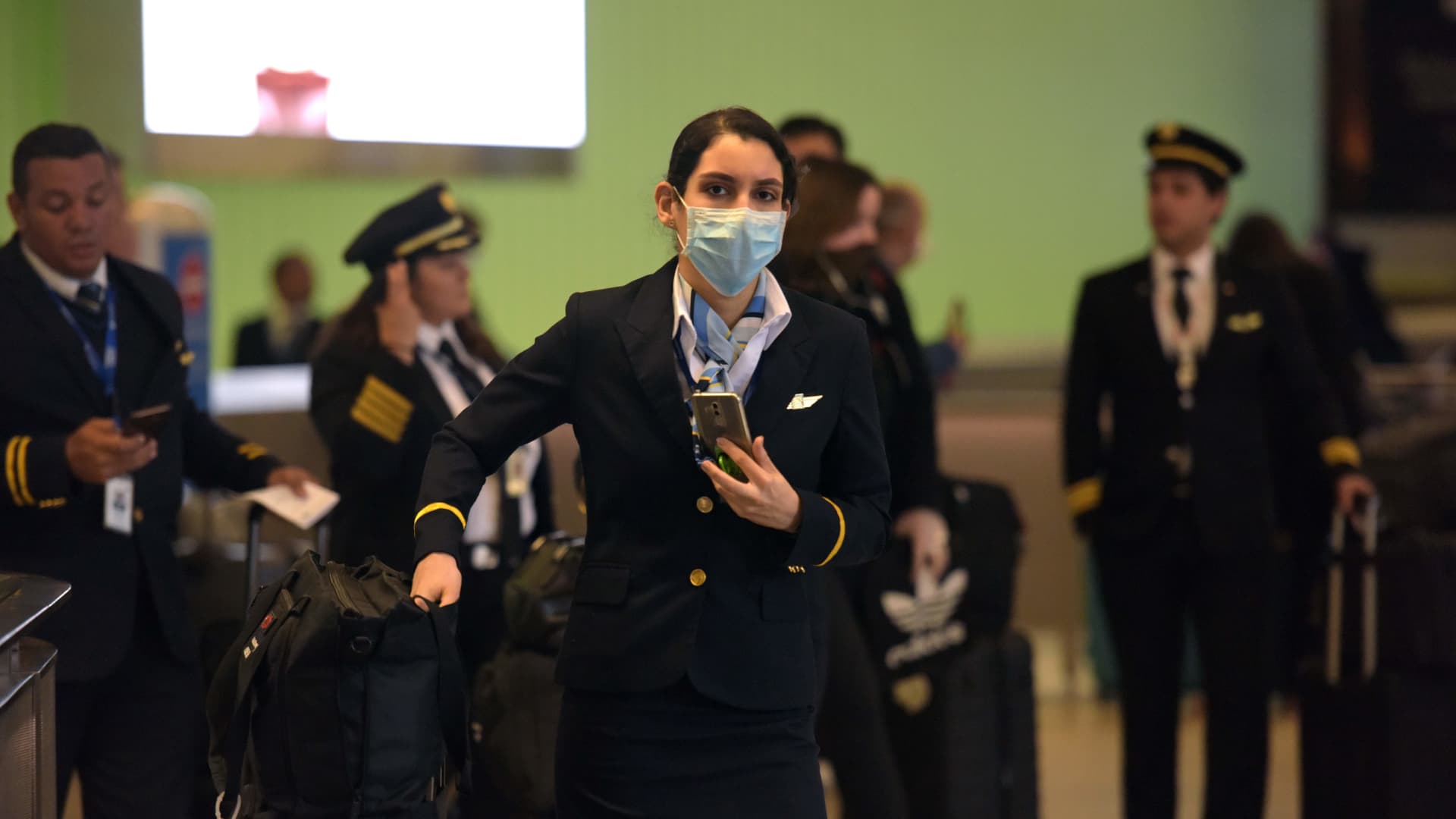 A flight attendant arrives at Tom Bradley Terminal at Los Angeles International airport in Los Angeles, California on March 16, 2020.
