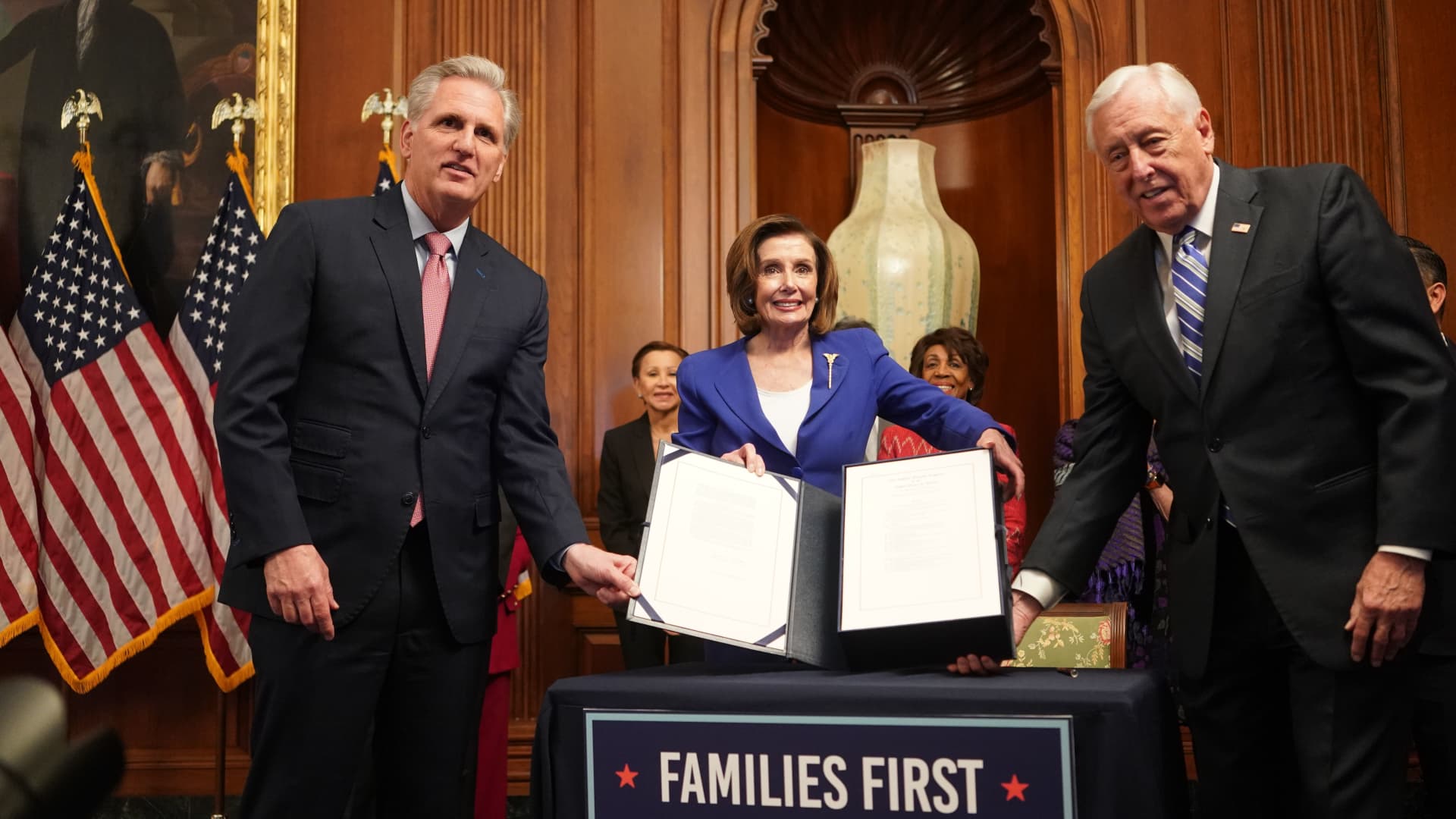 U.S. Speaker of the House Nancy Pelosi, center, and Reps. Kevin McCarthy, left, and Steny Hoyer show the $2 trillion stimulus bill passed by the House at a news conference in the U.S. Capitol in Washington, March 27, 2020.