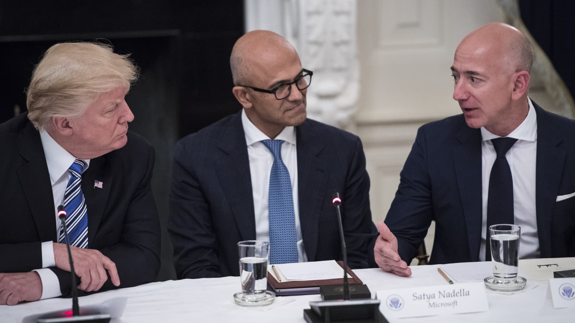 President Donald Trump speaks with Satya Nadella, Chief Executive Officer of Microsoft, and Jeff Bezos, Chief Executive Officer of Amazon during an American Technology Council roundtable in the State Dinning Room at the White House in Washington on June 19, 2017.