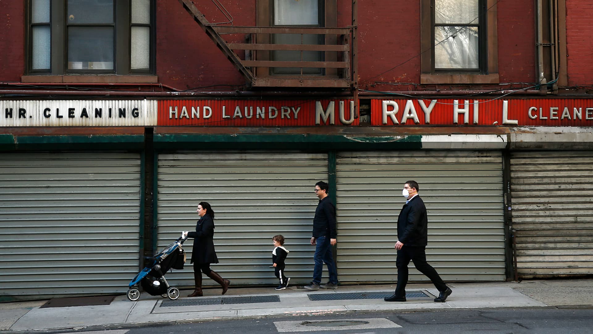 Pedestrians walk past closed shops along Lexington Avenue amid the coronavirus pandemic on April 7, 2020 in New York City.