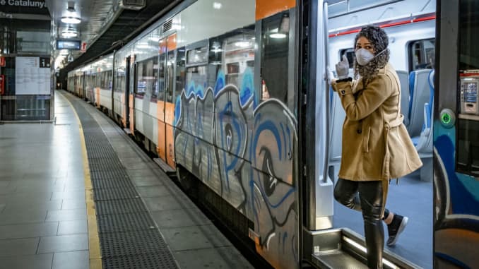 A woman wearing a sanitary mask as a preventive measure, leaving the train during the first day of work for non-essential sectors. Barcelona faces its 31st day of house confinement due to the contagion of Covid-19.