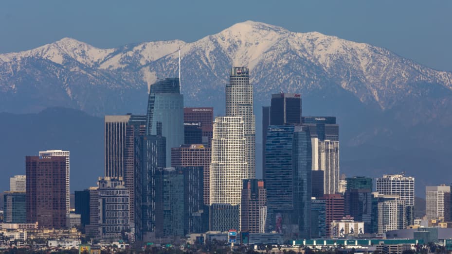 Snow is seen on the San Gabriel Mountains beyond downtown Los Angeles under a clear sky after weeks of storms and reduced traffic as coronavirus infections accelerate in the region on April 14, 2020 in Los Angeles, California.
