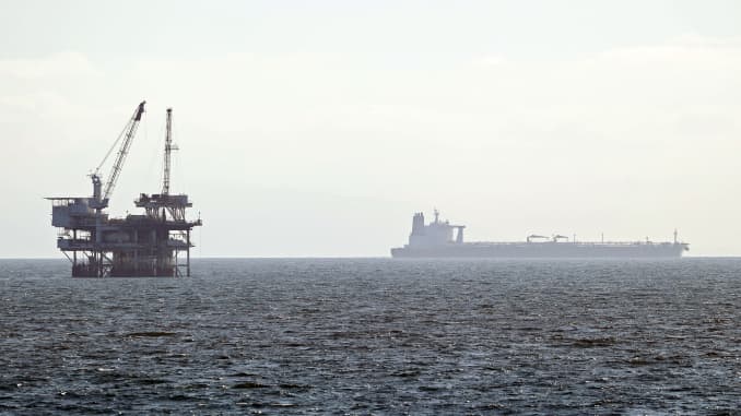 An offshore oil platform is seen with a tanker in the distance on April 20, 2020 in Huntington Beach, California.