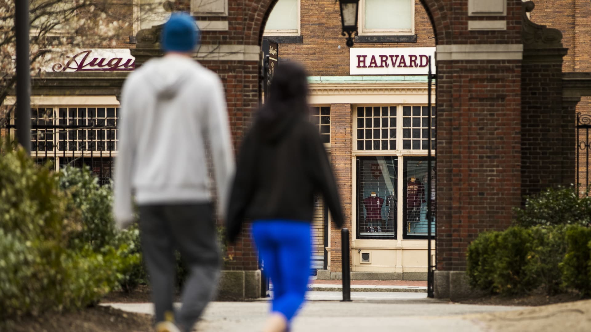 Pedestrians walk through Harvard Yard on the closed Harvard University campus in Cambridge, Massachusetts, U.S., on Monday, April 20, 2020.