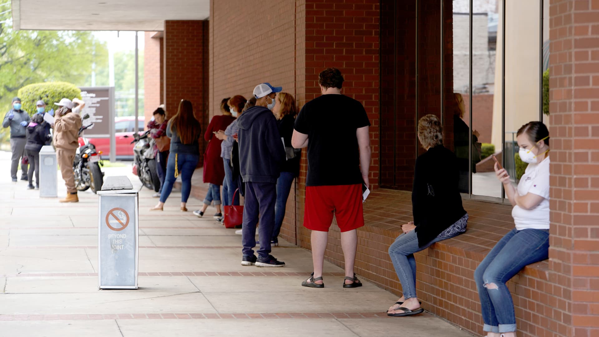 People who lost their jobs wait in line to file for unemployment following an outbreak of the coronavirus disease (COVID-19), at an Arkansas Workforce Center in Fort Smith, Arkansas, U.S. April 6, 2020.