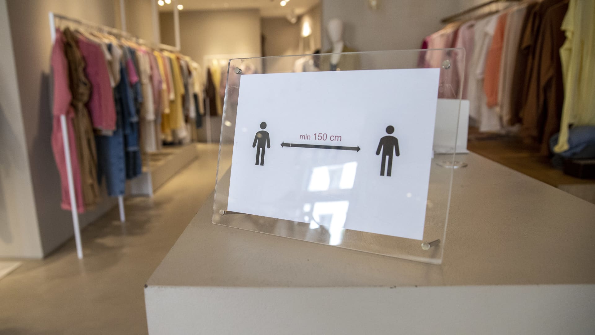 A sign that reminds clients to keep 1.5m distance in a clothes store as they open for the first time since March during the coronavirus (COVID-19) pandemic on April 22, 2020 in Berlin, Germany.