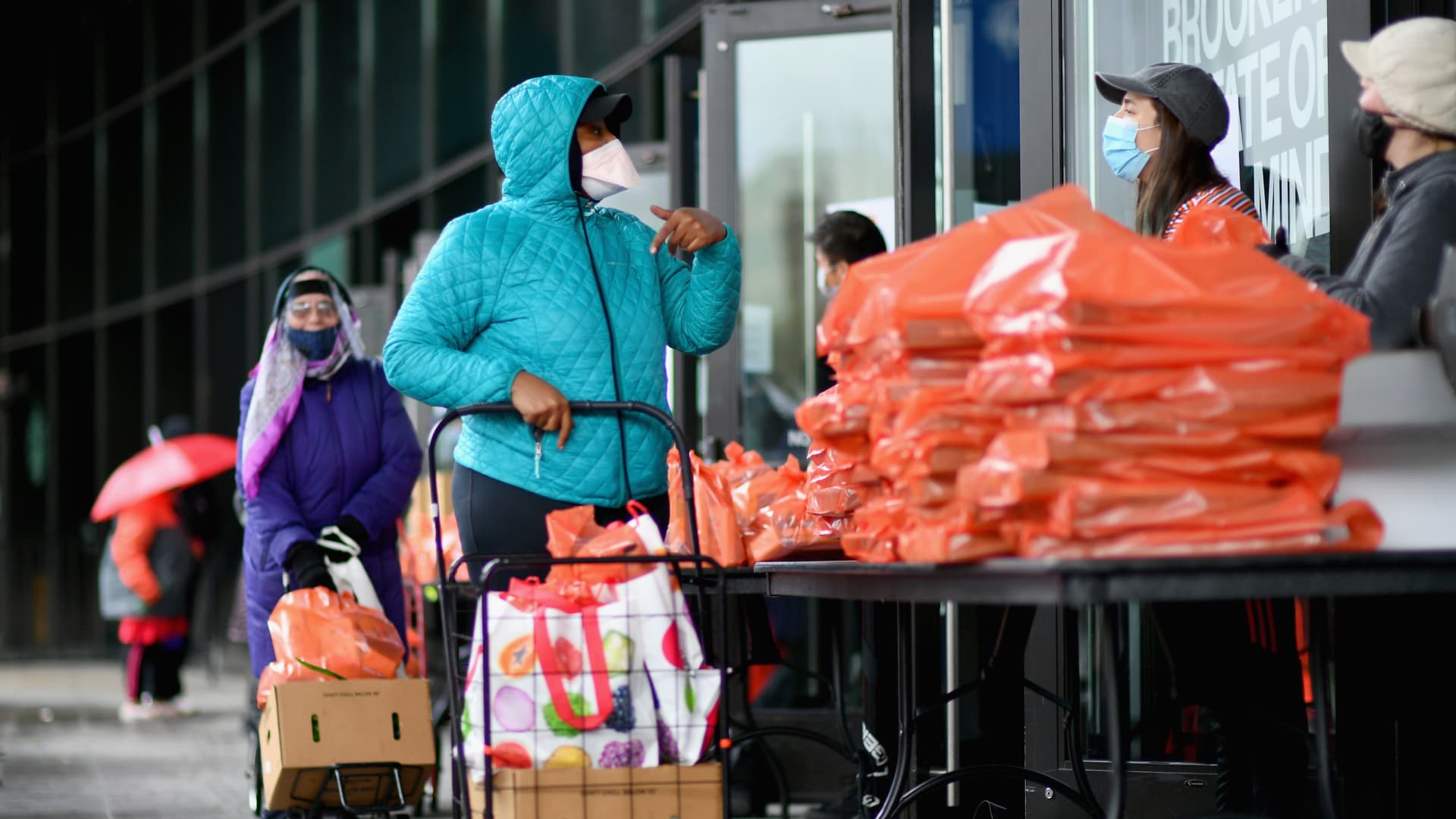 People pick up food the Food Bank at the New York City mobile food pantry on the Barclays Center plaza on April 24, 2020 in the Brooklyn, New York.