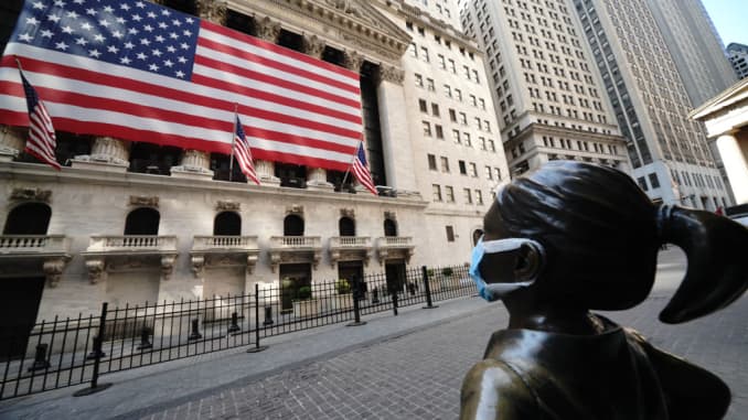 A view of the fearless girl wearing a mask in front of the New York Stock Exchange in New York City USA during coronavirus pandemic on April 25, 2020.