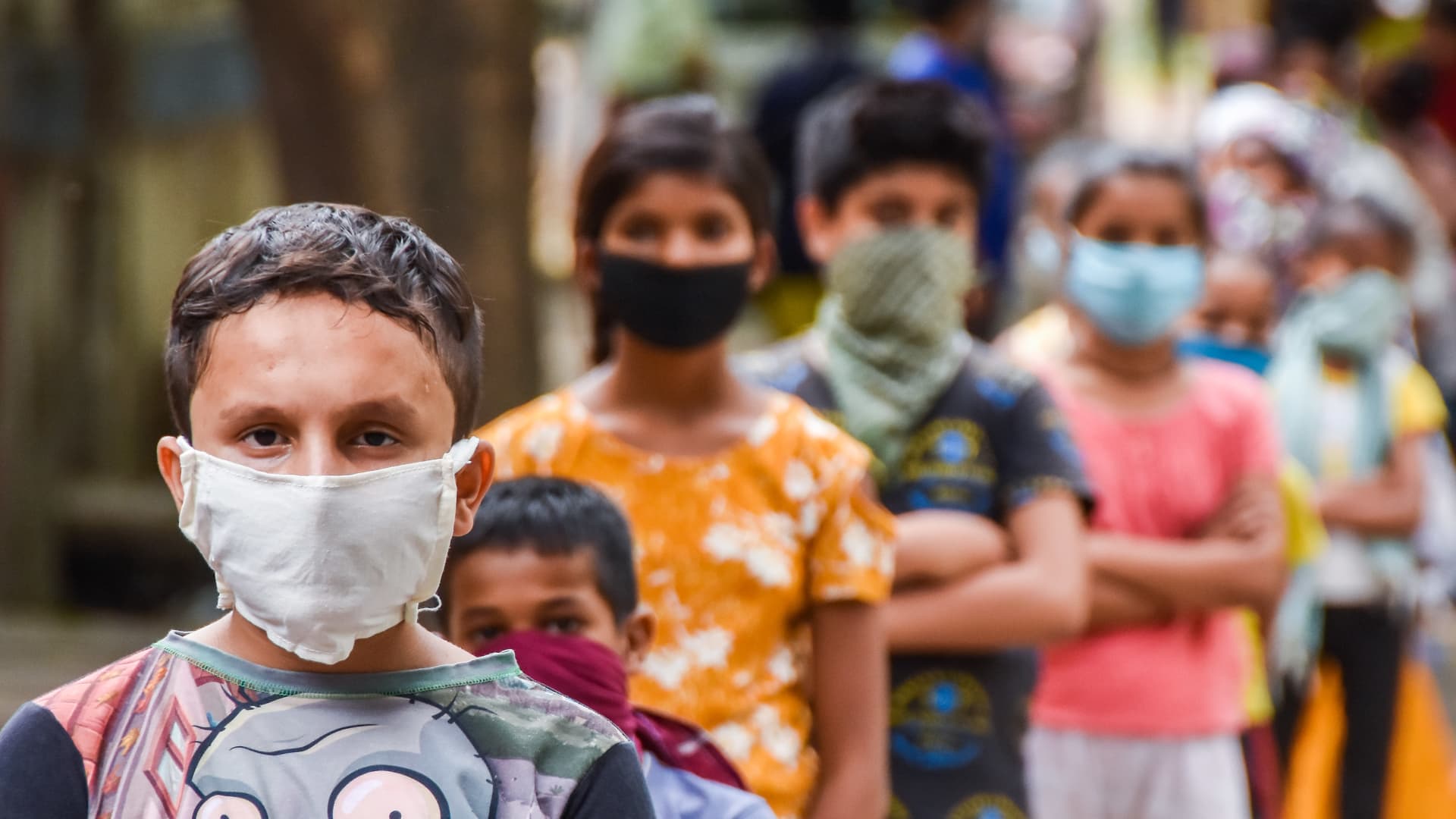 Kids in a queue while wearing face masks during the food distribution amid Coronavirus COVID 19.