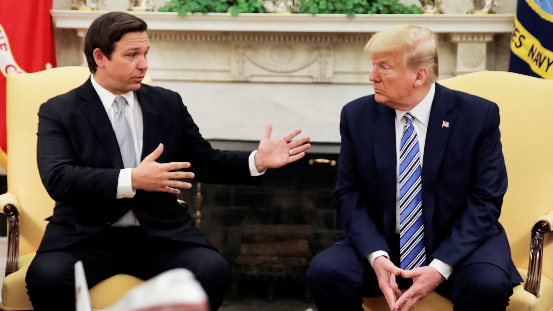 U.S. President Donald Trump listens to Florida Governor Ron DeSantis speak about the coronavirus response during a meeting in the Oval Office at the White House in Washington, U.S., April 28, 2020.