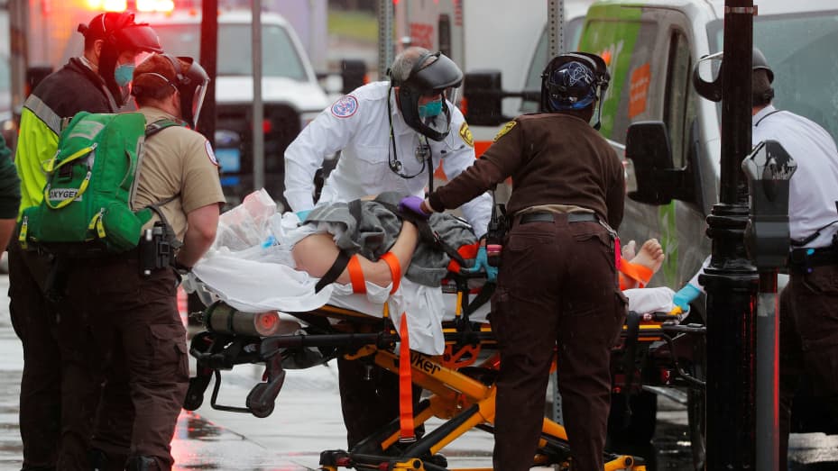 Boston EMS medics work to resuscitate a patient on the way to the ambulance amid the coronavirus disease (COVID-19) outbreak in Boston, Massachusetts, April 27, 2020.