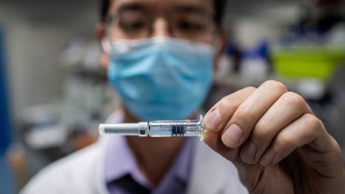 In this picture taken on April 29, 2020, an engineer shows an experimental vaccine for the COVID-19 coronavirus that was tested at the Quality Control Laboratory at the Sinovac Biotech facilities in Beijing.