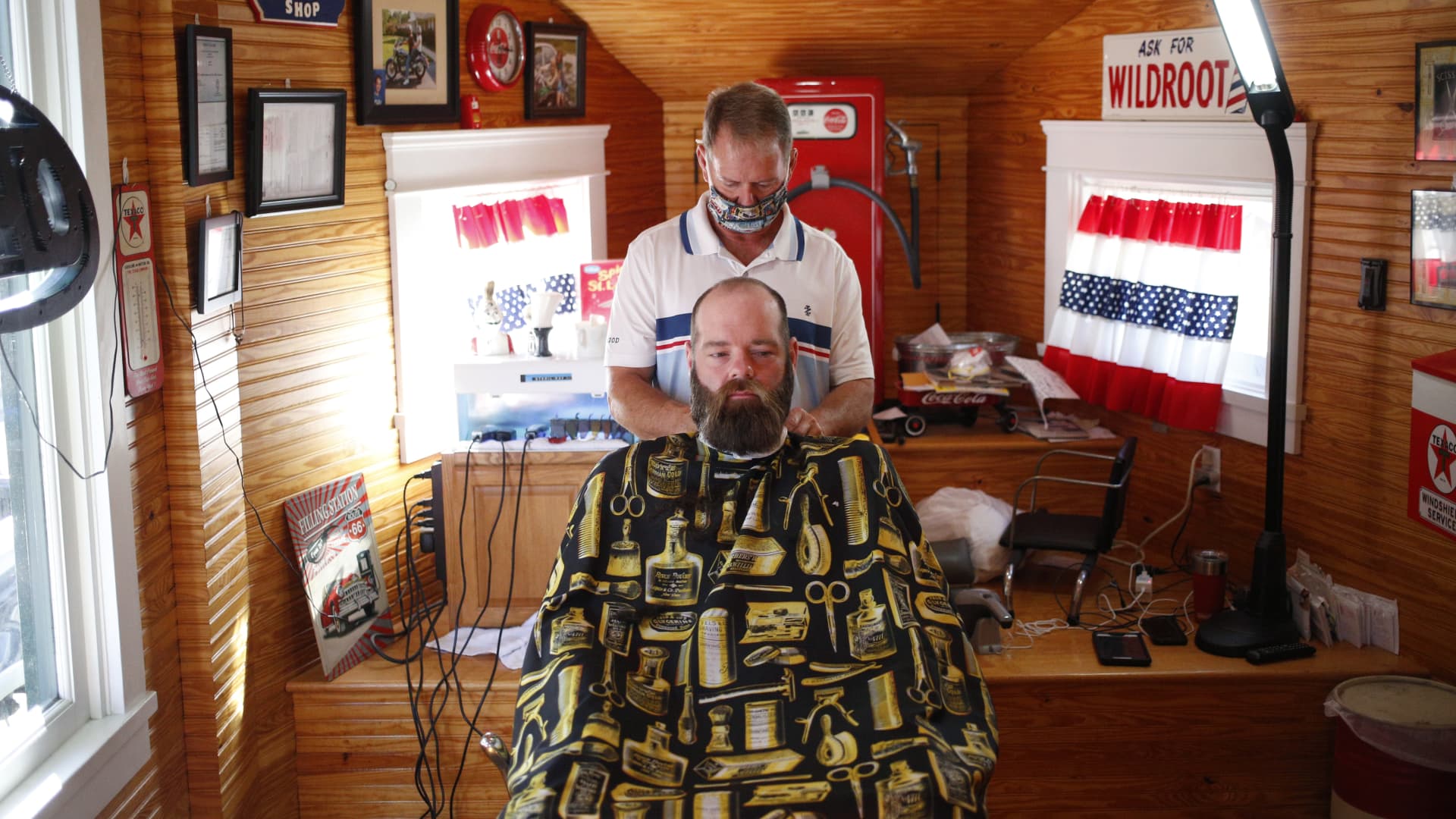 A customer gets a haircut at John's Barber Shop in Knoxville, Tennessee, May 1, 2020.