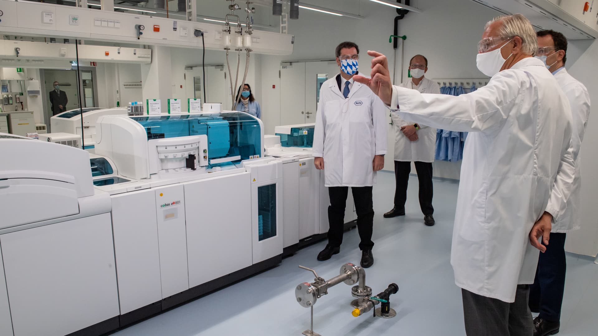 Markus Söder (l-r, CSU), Prime Minister of Bavaria, Joachim Eberle, Head of Research Diagnostic Roche, Christoph Franz, Chairman of the Board of Directors of Roche, and Jens Spahn (CDU), German Federal Minister of Health, visit the Roche development laboratory for the new serological antibody test Elecsys Anti-SARS-CoV-2.