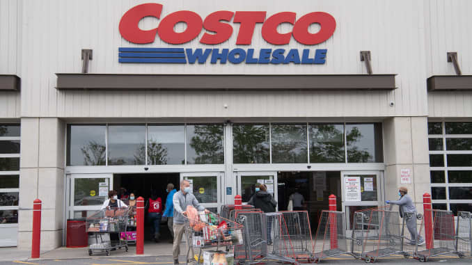 Shoppers walk out with full carts from a Costco store in Washington, DC, on May 5, 2020.