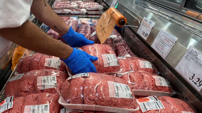 A worker stacks packets of ground beef in the meat section of a Costco warehouse club during the coronavirus disease (COVID-19) pandemic in Webster, Texas, May 5, 2020.