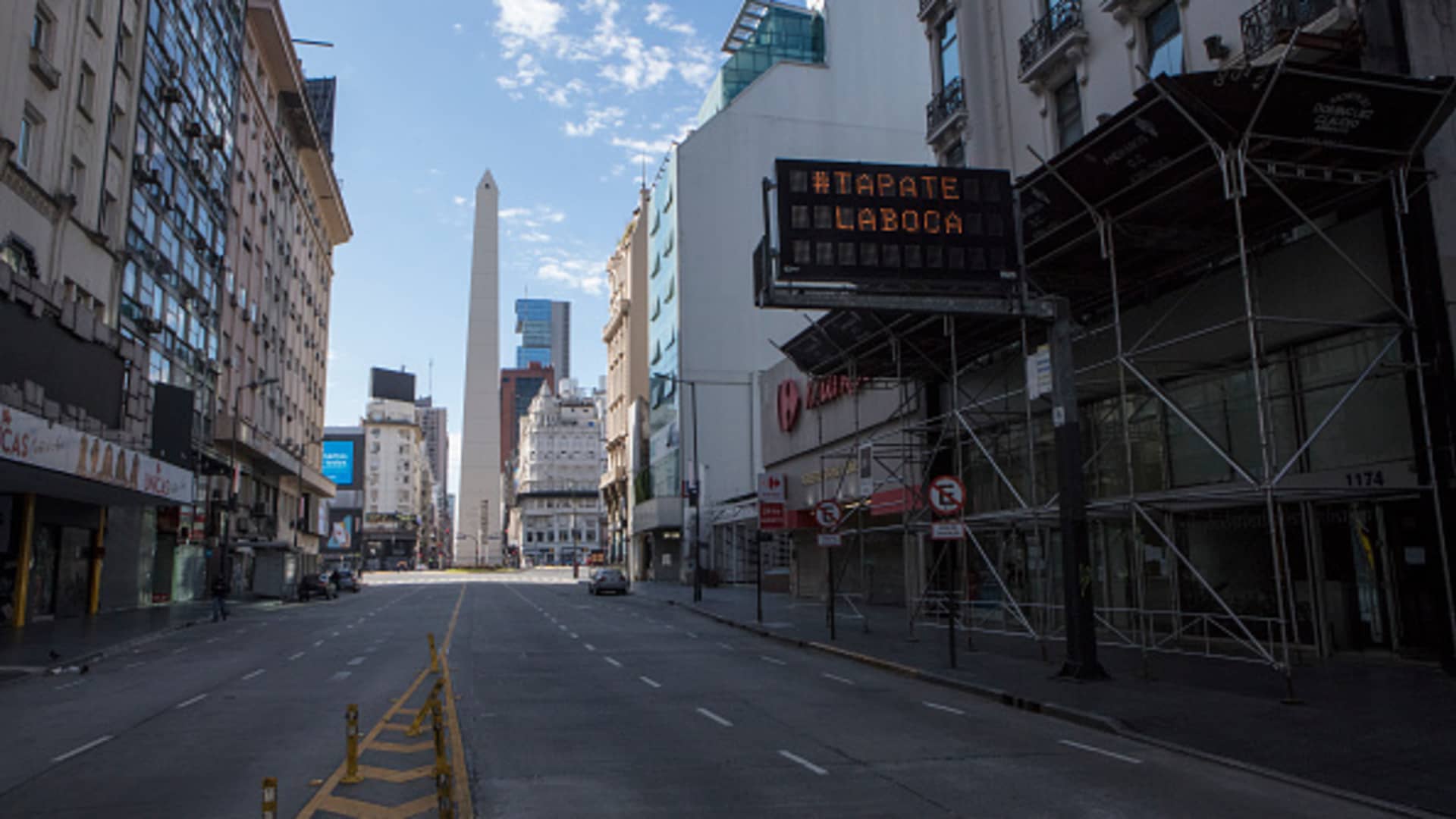 Signal hanging with a message in Spanish that reads 'protect your mouth with a mask' in the empty Buenos Aires obelisk landscape during the government-ordered lockdown on May 01, 2020 in Buenos Aires, Argentina.