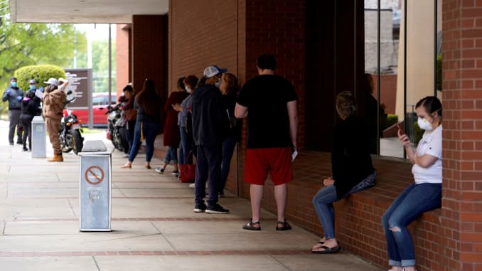 People who lost their jobs wait in line to file for unemployment following an outbreak of the coronavirus disease (COVID-19), at an Arkansas Workforce Center in Fort Smith, Arkansas, U.S. April 6, 2020.