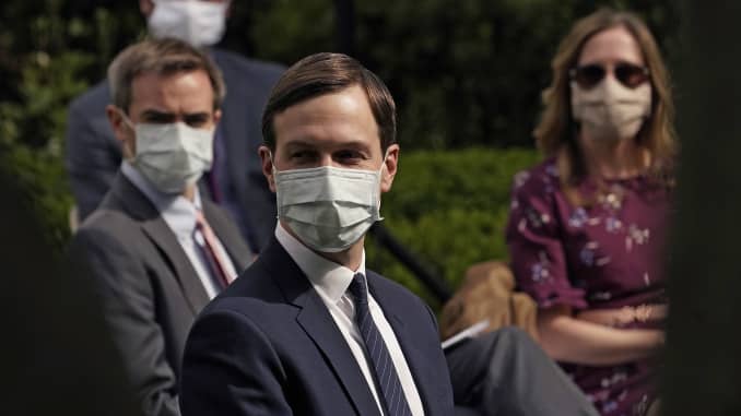 White House advisor Jared Kushner (C) and others wear face masks while attending a press briefing about coronavirus testing in the Rose Garden of the White House on May 11, 2020 in Washington, DC.