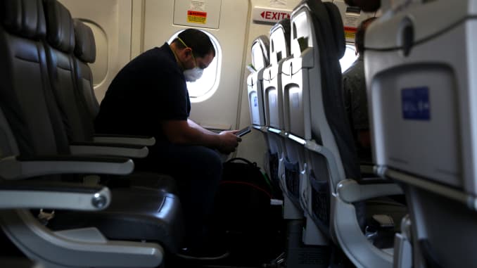 A passenger looks at his phone while waiting aboard a United Airlines plane before taking off from George Bush Intercontinental Airport on May 11, 2020 in Houston, Texas.